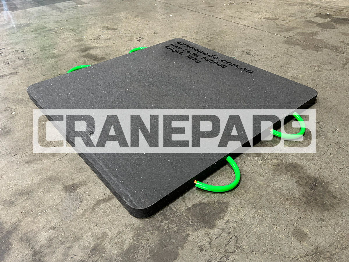 Black crane pad with green edges on a concrete floor, featuring the brand 'CRANEPADS'.