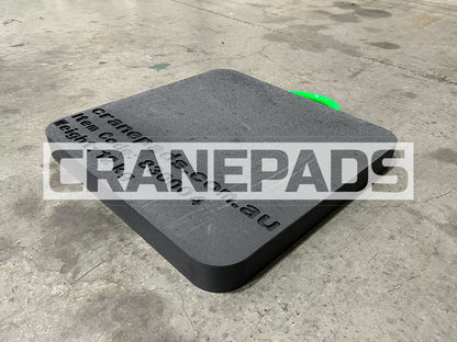Black crane pad on a concrete floor with 'CRANEPADS' branding.