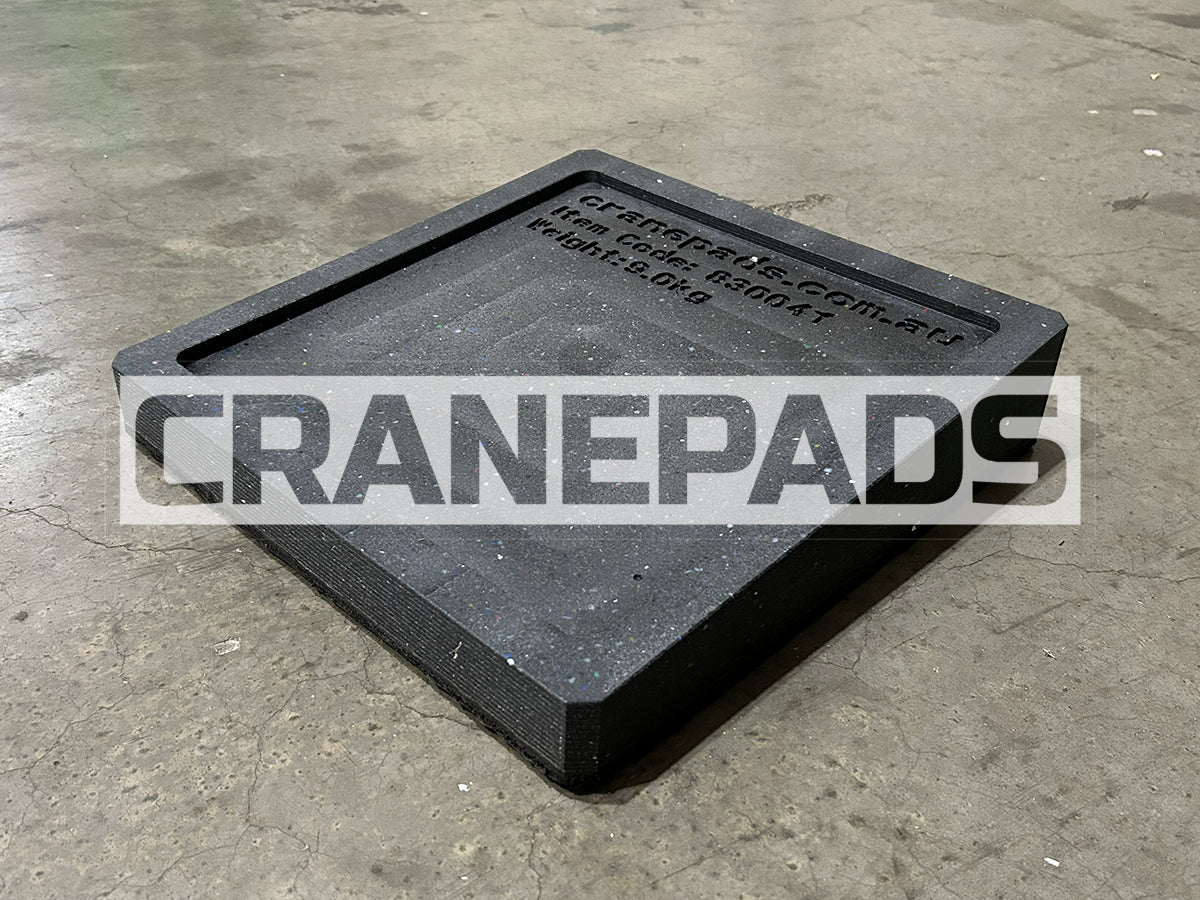 Black crane pad on a concrete floor with 'CRANEPADS' branding.