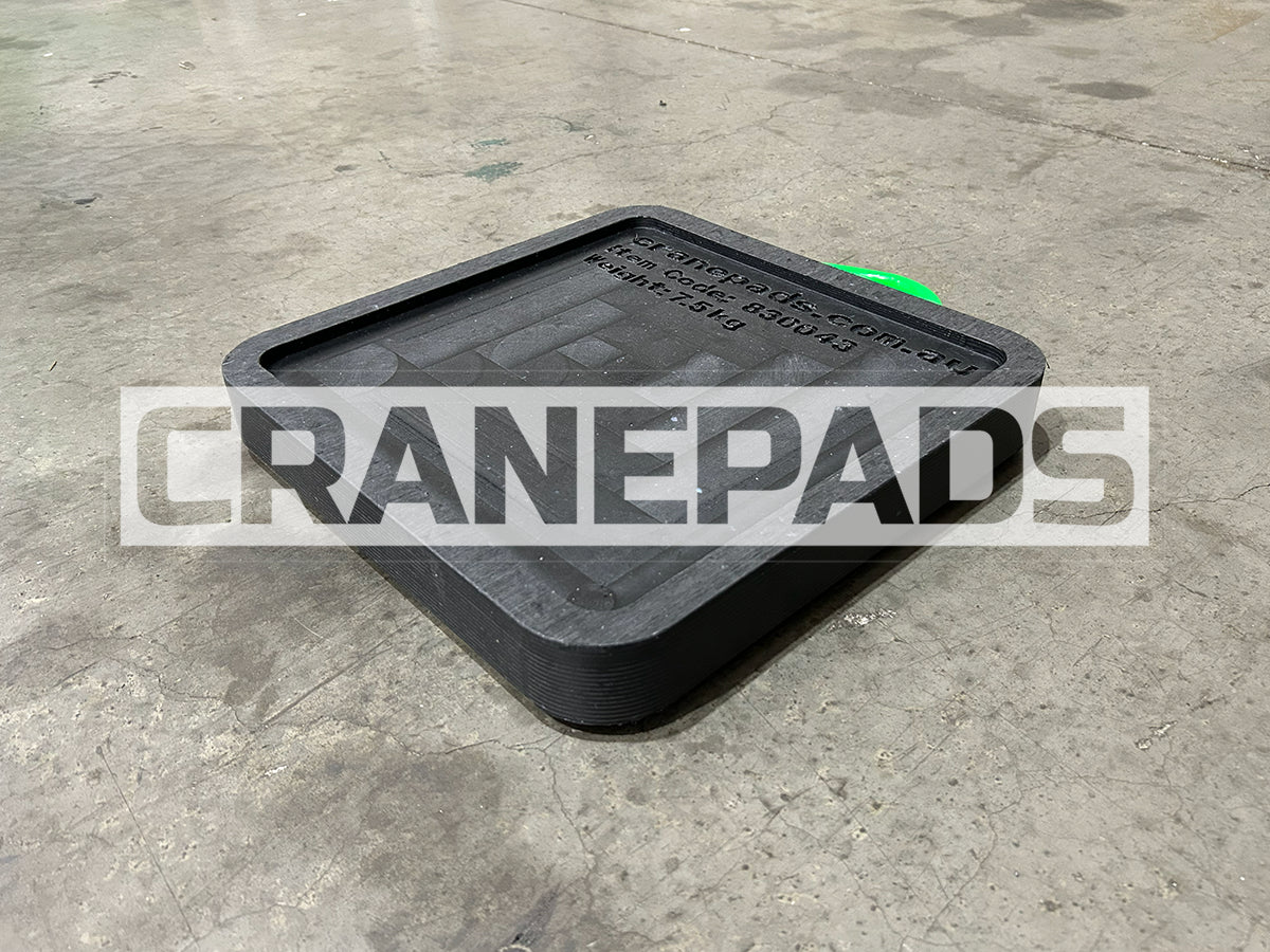 Black rubber crane pad on a concrete floor with 'CRANEPADS' branding.